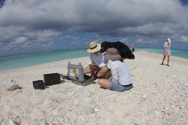 The survey team setting up equipment on the sand cay