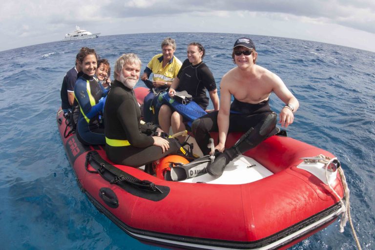 Expedition members in an inflatable tender at sea