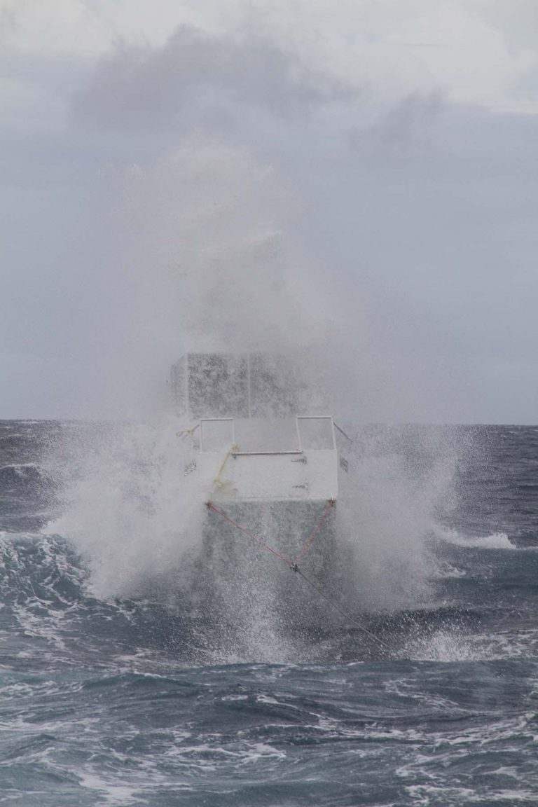 A small boat crashing through waves