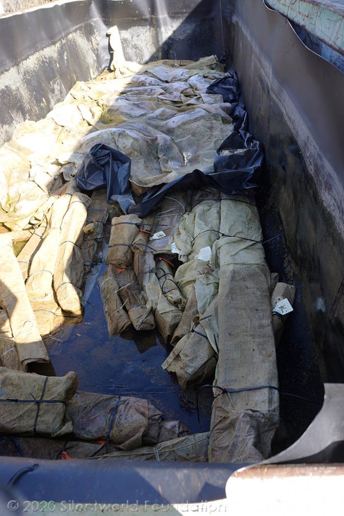 Wrapped boat timbers in a storage tank