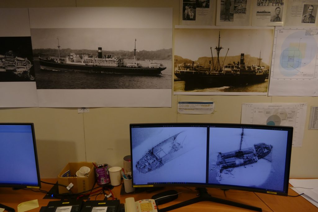 Screens showing sonar imagery of the wreck beside historical photographs of the ship