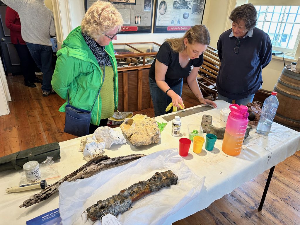 Heather Berry examining artefacts brought in by community members